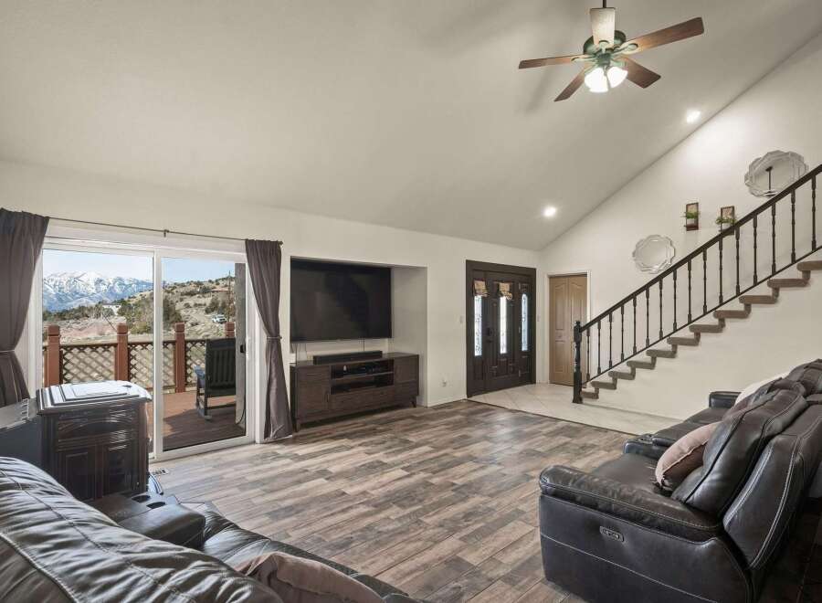 This stunning property boasts a spacious living area with a modern entertainment setup, perfect for relaxation and gatherings.