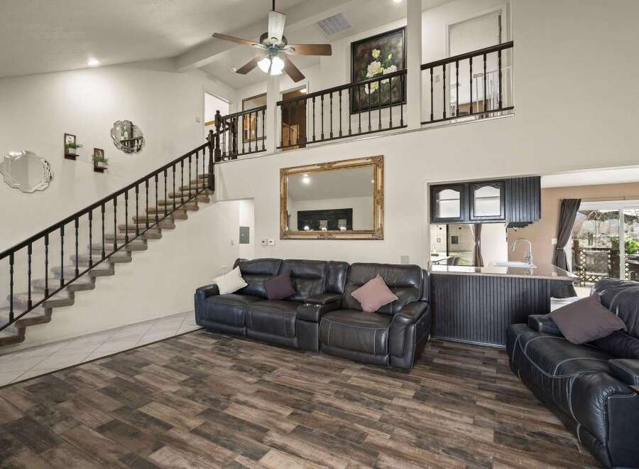This stunning property boasts a spacious living area with a modern design and high ceilings.