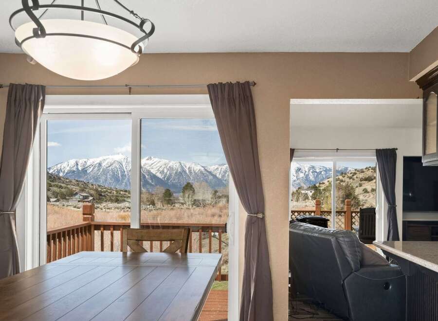 Enjoy breathtaking mountain views from this stunning property! This home features a spacious dining area with large windows, perfect for entertaining.
