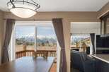 Enjoy breathtaking mountain views from this stunning property! This home features a spacious dining area with large windows, perfect for entertaining.