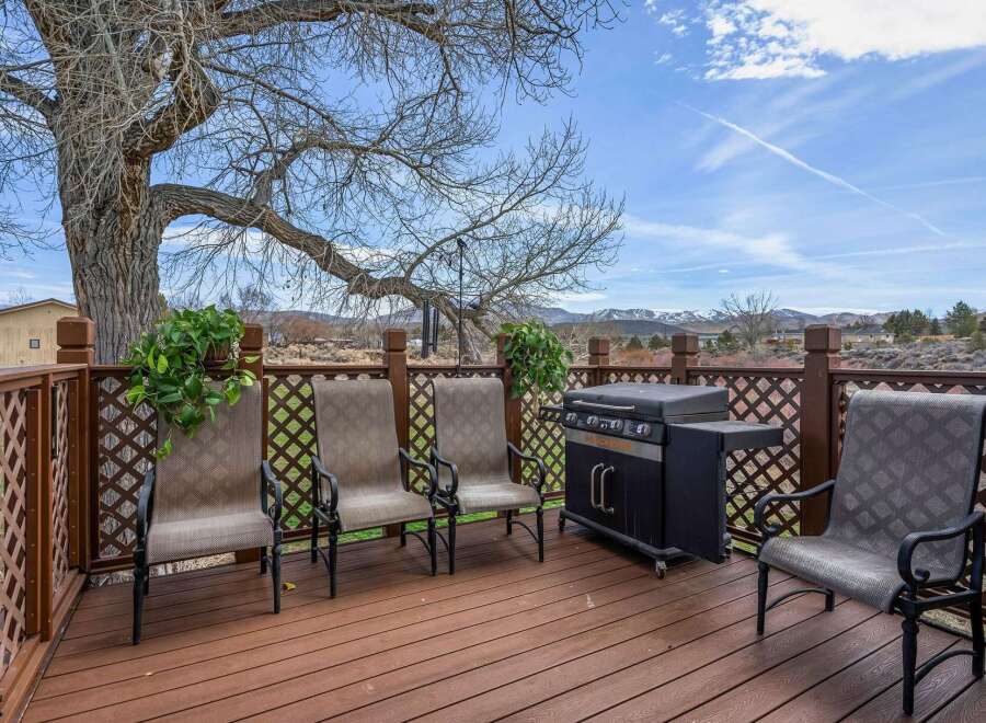 Enjoy outdoor living at its finest on this beautiful deck! Featuring a built-in grill and comfortable seating, this space is perfect for entertaining or relaxing.