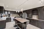 This stunning kitchen boasts dark wood cabinetry, offering a sophisticated and timeless aesthetic.