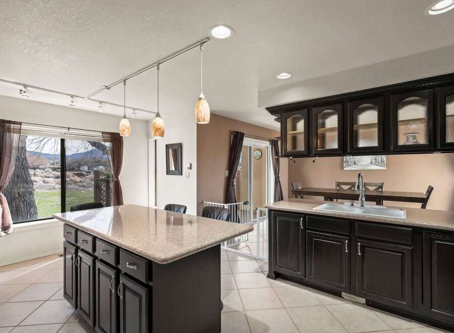 This stunning kitchen boasts a spacious island with ample storage, perfect for meal prep and entertaining.