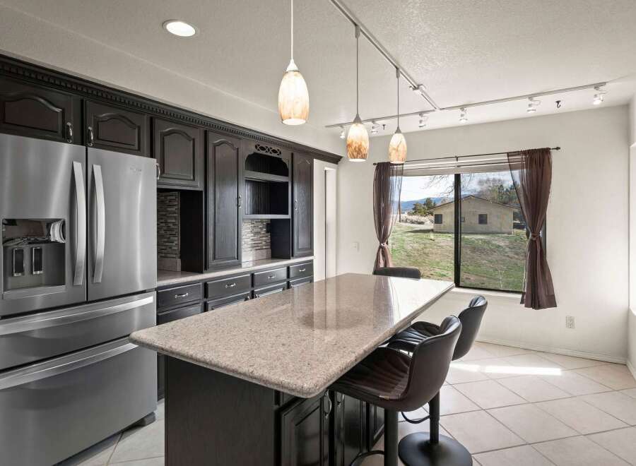 This stunning kitchen boasts a modern design with sleek cabinetry and a spacious island, perfect for both cooking and entertaining.