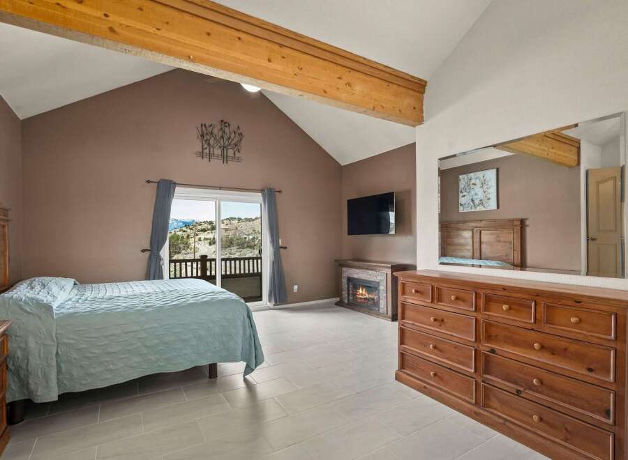 This stunning bedroom boasts a cozy fireplace, perfect for those chilly evenings.