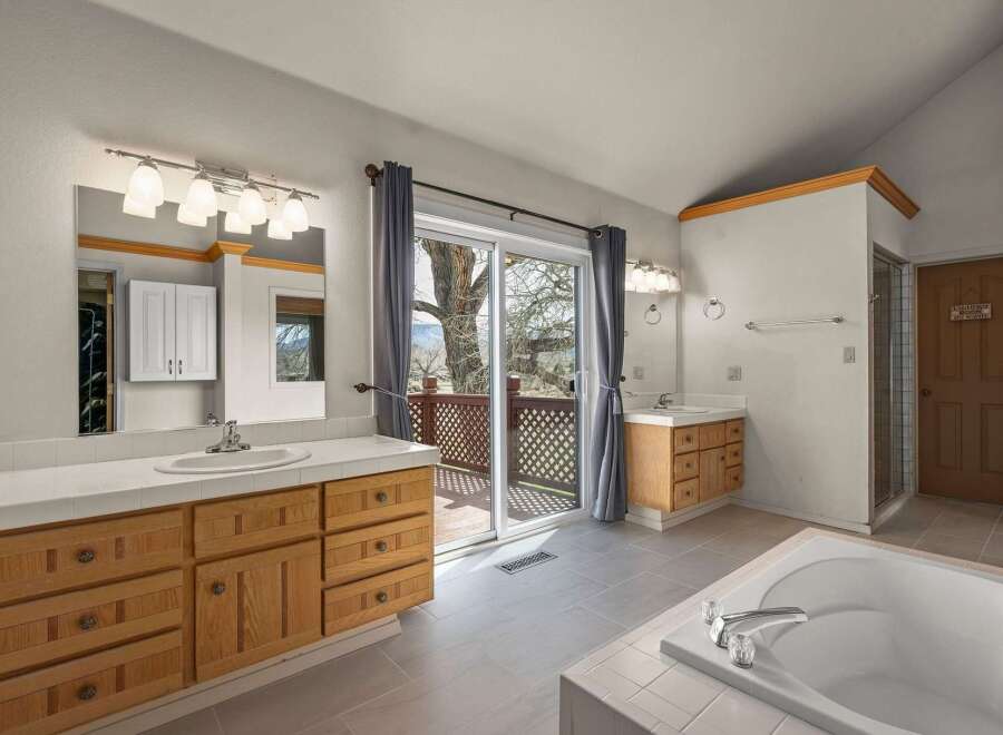 Step into luxury with this spacious bathroom featuring a stunning view.