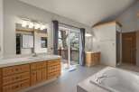 Step into luxury with this spacious bathroom featuring a stunning view.