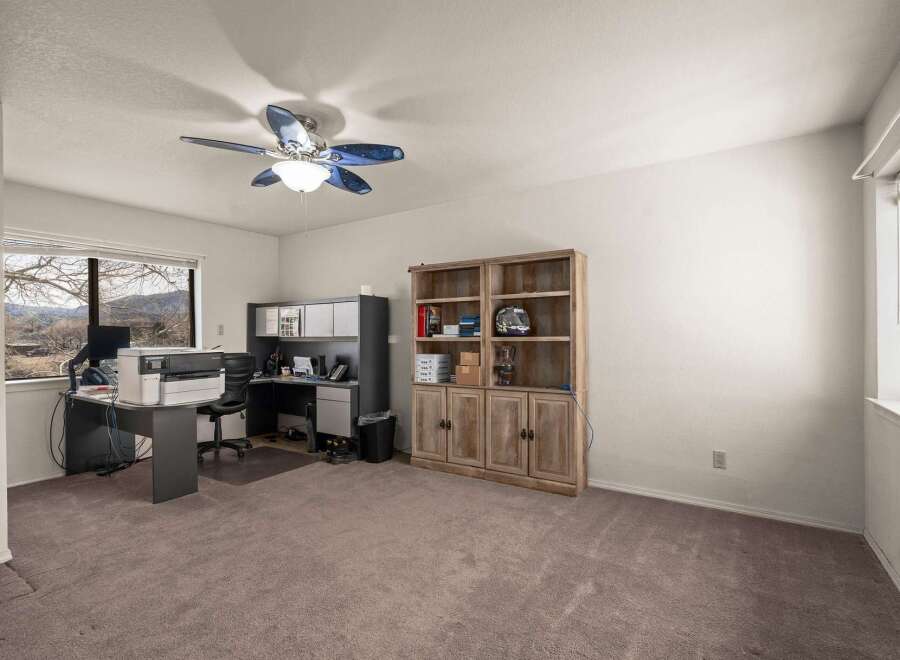 This inviting home office features a spacious layout with ample natural light.