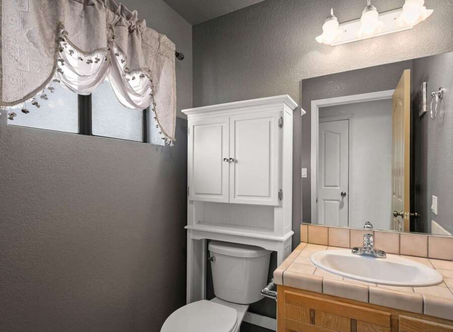 This charming bathroom features a bright and airy design, perfect for starting your day.