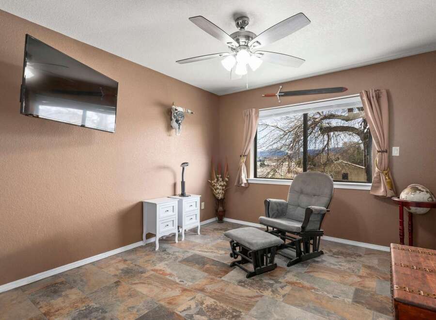 This inviting room features a cozy rocking chair and ottoman, perfect for relaxation.