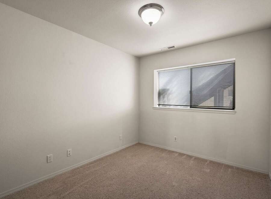 Discover the potential of this inviting space! This room features neutral walls, perfect for customization, and plush carpeting underfoot.