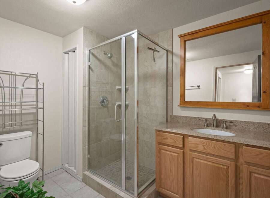 Step into this inviting bathroom featuring a modern glass shower enclosure.