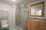 Step into this inviting bathroom featuring a modern glass shower enclosure.