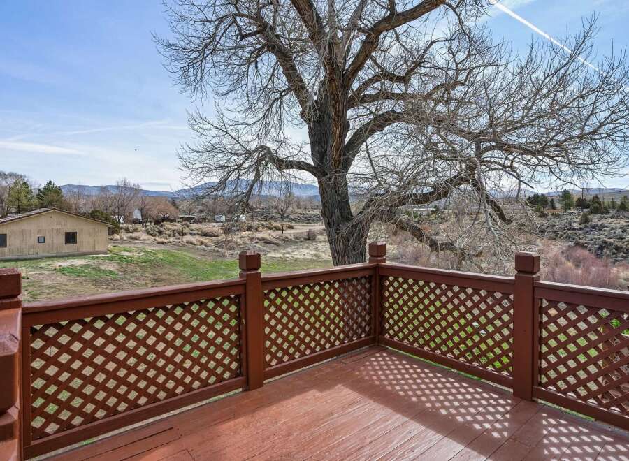 Enjoy breathtaking views from this charming property! This home features a spacious deck with a beautiful lattice railing, perfect for relaxing and taking in the surrounding scenery.