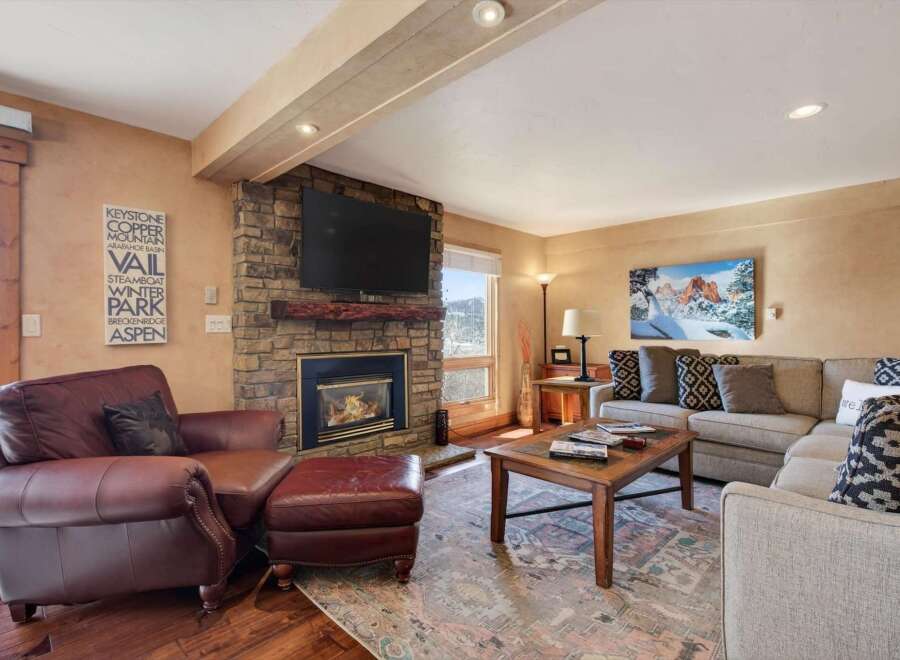 Experience the warmth and comfort of this stunning living room, featuring a cozy fireplace and a stylish seating area.
