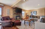 Experience the warmth and comfort of this stunning living room, featuring a cozy fireplace and a stylish seating area.