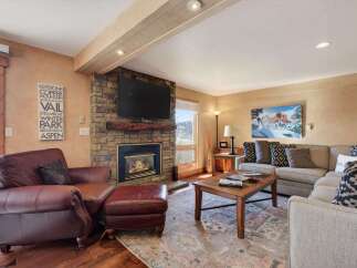 Experience the warmth and comfort of this stunning living room, featuring a cozy fireplace and a stylish seating area.