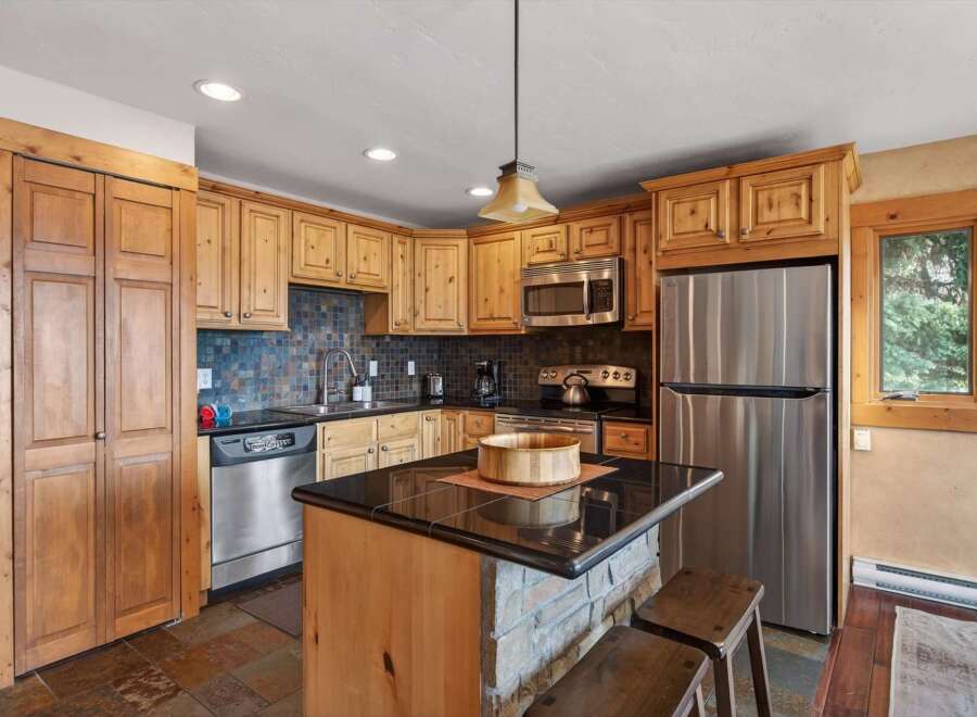 This stunning kitchen boasts beautiful wooden cabinetry and modern stainless steel appliances.
