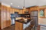 This stunning kitchen boasts beautiful wooden cabinetry and modern stainless steel appliances.