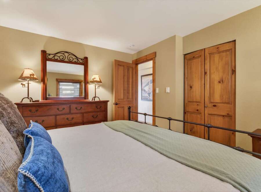 Discover the charm of this inviting bedroom, featuring a cozy bed and a stylish dresser.