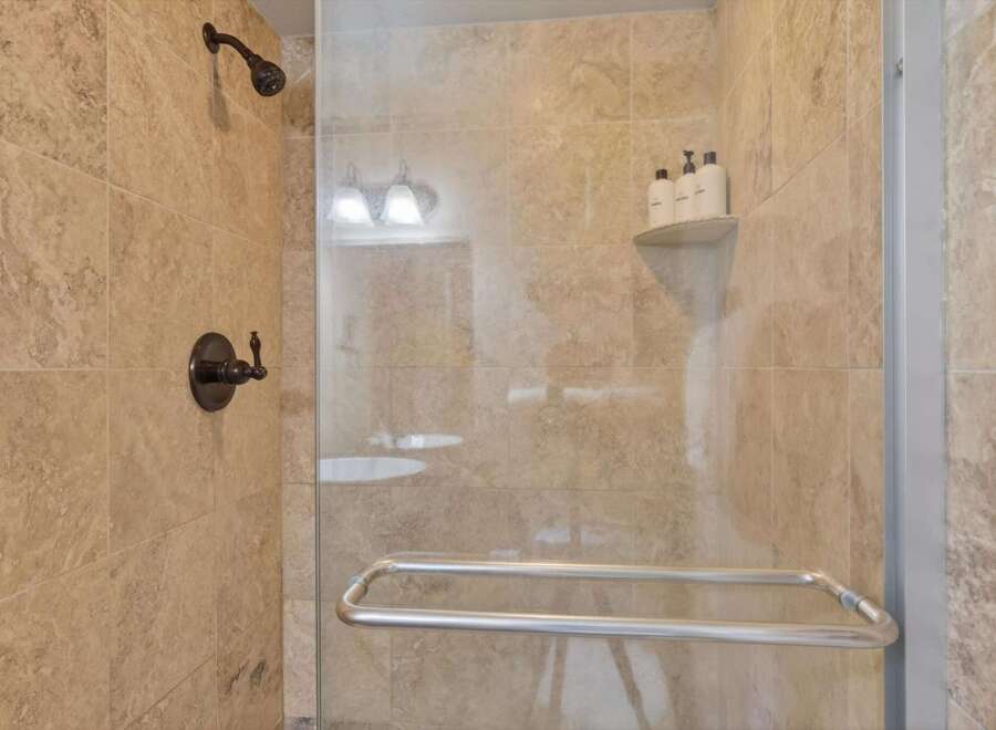 Step into luxury with this stunning shower! Featuring elegant tile work and modern fixtures, this space offers a spa-like experience.