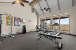 This spacious home gym offers a variety of workout equipment, including a treadmill, elliptical, and weight bench.