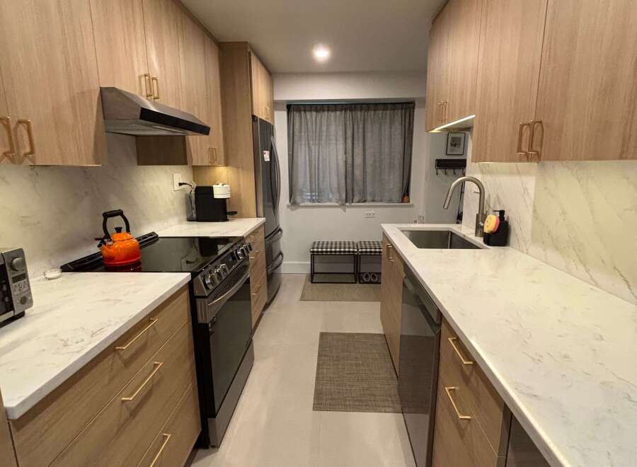 This stunning kitchen features modern cabinetry, sleek countertops, and stainless steel appliances.