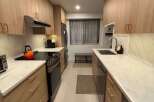 This stunning kitchen features modern cabinetry, sleek countertops, and stainless steel appliances.