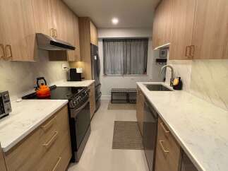 This stunning kitchen features modern cabinetry, sleek countertops, and stainless steel appliances.