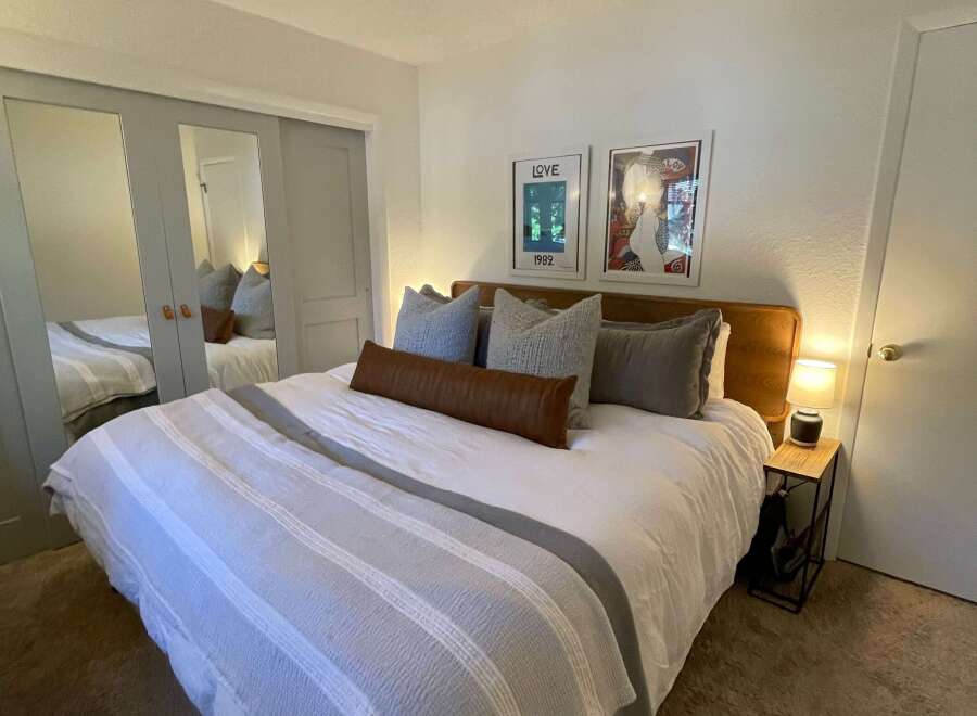 This cozy bedroom features a comfortable bed with stylish bedding and decorative pillows.