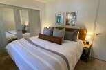 This cozy bedroom features a comfortable bed with stylish bedding and decorative pillows.