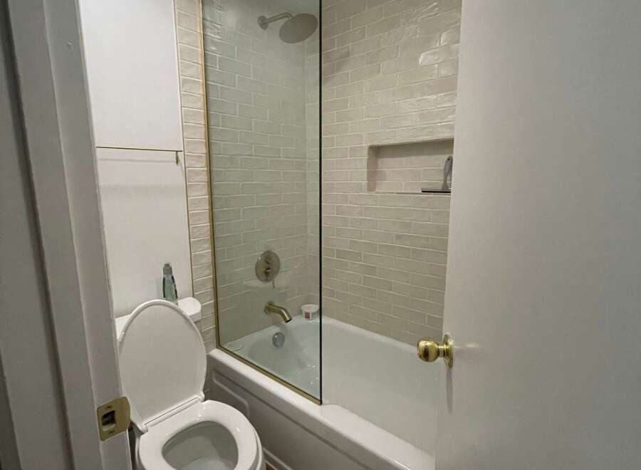 Step into this beautifully designed bathroom featuring a modern glass shower enclosure and elegant tile work.