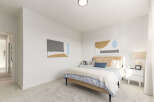 This stunning bedroom offers a serene retreat with its modern design and ample natural light.