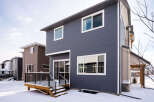 This stunning property boasts a modern exterior with sleek siding and large windows, offering ample natural light.
