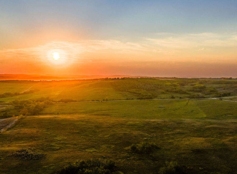 Experience the tranquility of this stunning property, offering breathtaking sunset views over rolling green fields.