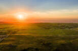 Experience the tranquility of this stunning property, offering breathtaking sunset views over rolling green fields.