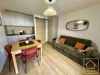 Discover this charming property featuring a cozy living space with a comfortable sofa and a dining area perfect for gatherings.