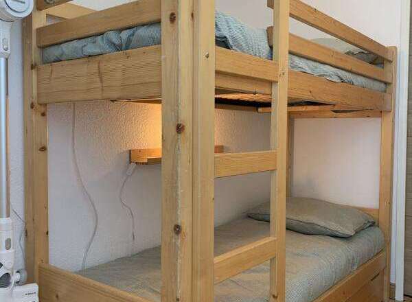 This cozy bunk bed offers a space-saving solution for a vacation rental or family home.