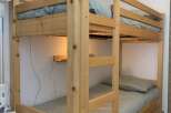 This cozy bunk bed offers a space-saving solution for a vacation rental or family home.