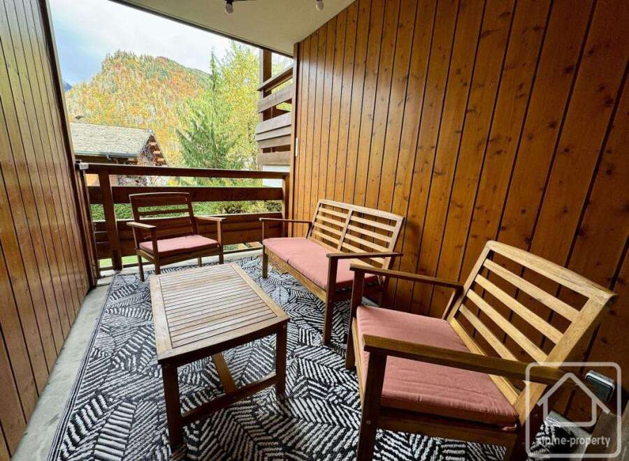 Enjoy the stunning mountain views from this cozy outdoor seating area.