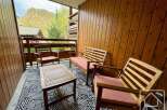 Enjoy the stunning mountain views from this cozy outdoor seating area.