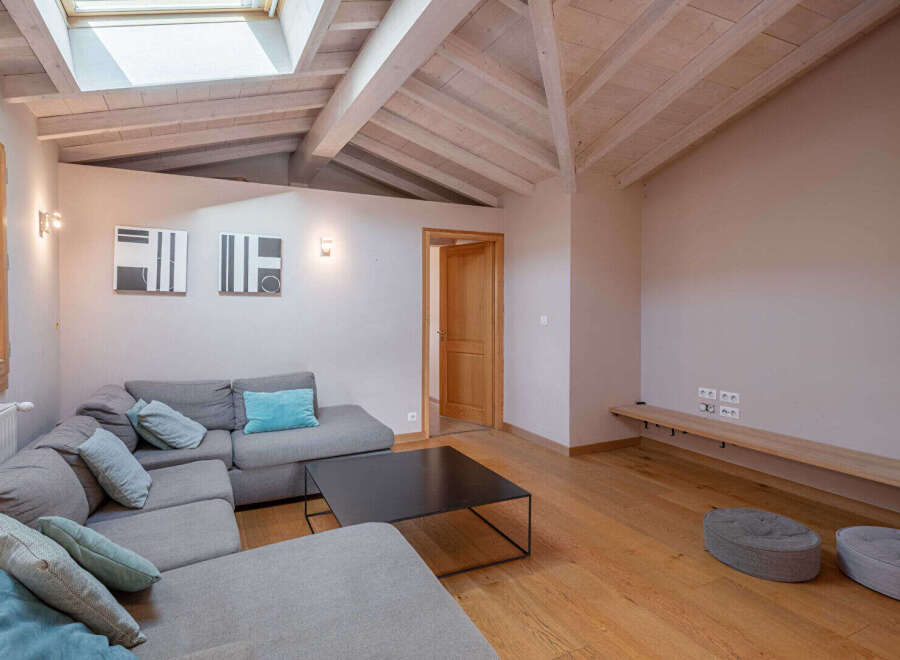 This stunning living room boasts a modern design with a cozy sectional sofa and a sleek black coffee table.