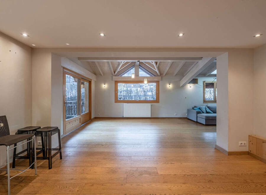 This stunning property boasts a spacious, open-plan living area with beautiful wooden floors and ample natural light.