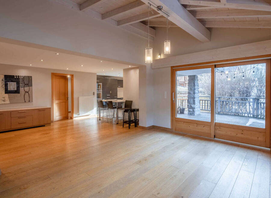 Step into this stunning property featuring a spacious, light-filled living area with beautiful wooden floors.