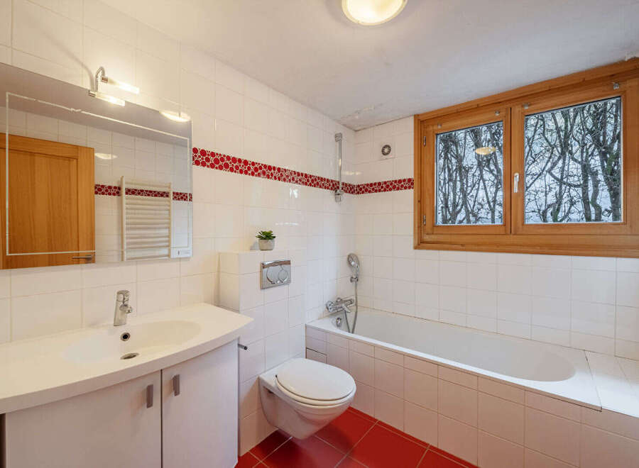 This charming bathroom features a bright and airy design, perfect for relaxation.