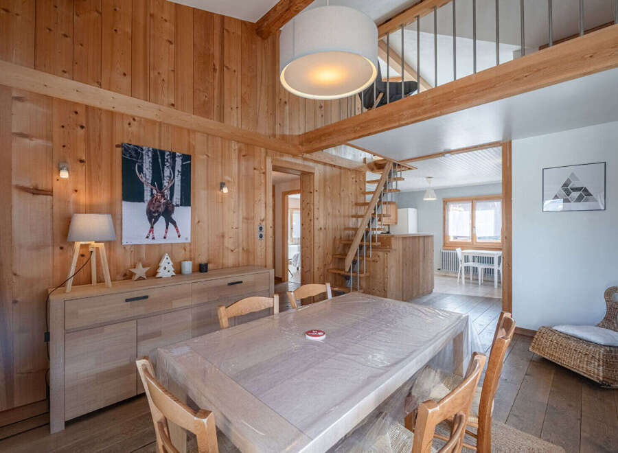 Step into this charming chalet-style home, boasting warm wooden interiors and a cozy atmosphere.