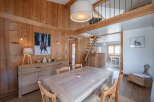 Step into this charming chalet-style home, boasting warm wooden interiors and a cozy atmosphere.