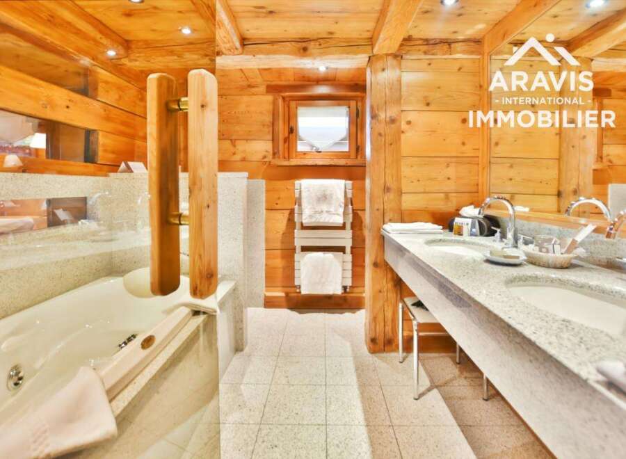 Experience luxury in this stunning bathroom featuring a jacuzzi tub and a double sink vanity.