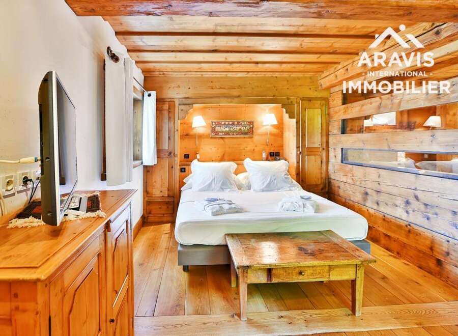 Experience the charm of this cozy bedroom featuring rustic wooden accents and a comfortable bed.