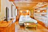 Experience the charm of this cozy bedroom featuring rustic wooden accents and a comfortable bed.